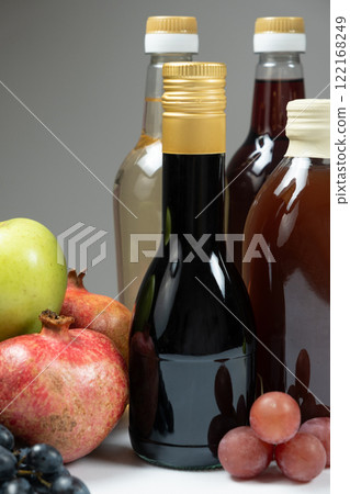 Different types of vinegar. Balsamic, pomegranate and apple vinegars in bottles Different types of vinegar. Balsamic, pomegranate and apple vinegars in bottles 122168249