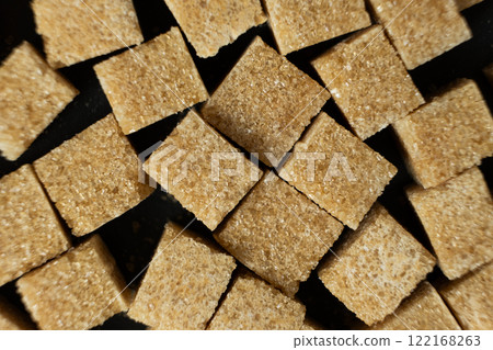 Cubes of brown cane unrefined demerara sugar. 122168263