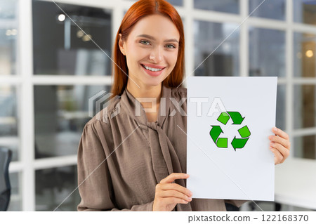 Smiling young woman presenting a waste recycling project 122168370