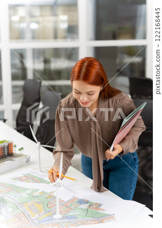 Female manager working in the office on planning a new project Female manager working in the office on planning a new project 122168445
