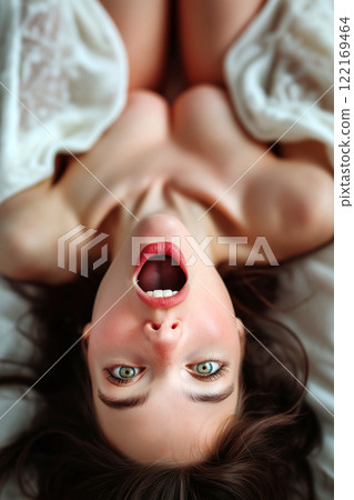 Erotic, sex, masturbation, cunnilingus, porn. Young woman having orgasm. Beautiful woman with open mouth enjoying sex lying in bed, wide open legs pose. Sexual experience, sensual pleasure. 122169464