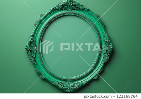 Elegant green round ornate picture frame with intricate decorative design placed on a monochromatic green background. A piece of artistic craftsmanship, vintage or classic art and decor concepts. 122169764