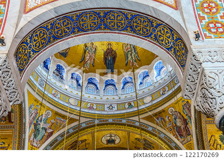 people pray in an Orthodox church, frescoes on the ceilings and walls of the church people pray in an Orthodox church, frescoes on the ceilings and walls of the church 122170269