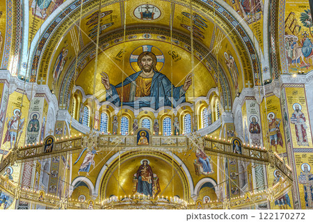 people pray in an Orthodox church, frescoes on the ceilings and walls of the church 122170272