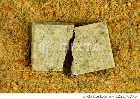 A versatile cube-shaped seasoning consisting of a mixture of vegetables and salt 122170770