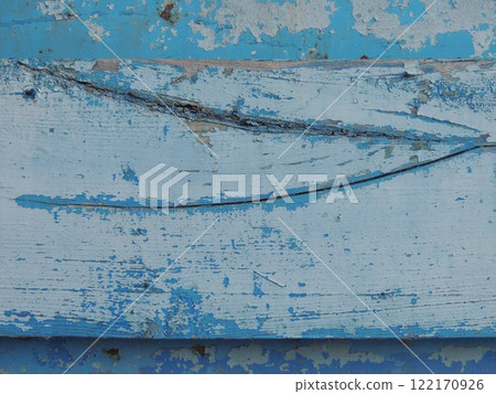 old board close-up with crack in structure and remains of blue paint, rustic exterior element made of wood and metal with flakes of peeling old blue paint old board close-up with crack in structure and remains of blue paint, rustic exterior element made of wood and metal with flakes of peeling old blue paint 122170926