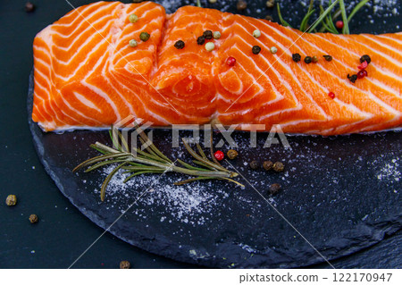 Raw salmon fillet with spices on black slate Raw salmon fillet with spices on black slate 122170947