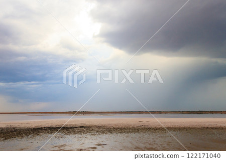 Dark storm clouds over a salt lake before a rain 122171040