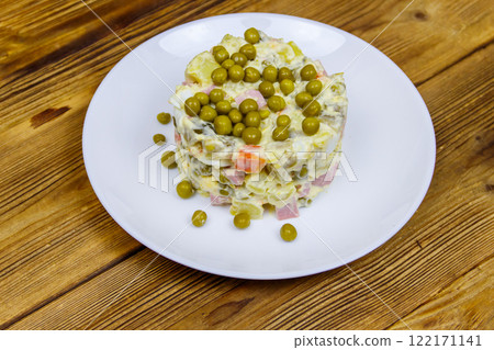 Traditional Russian festive salad Olivier on wooden table 122171141