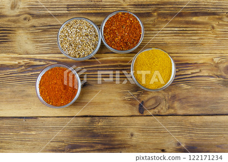 Set of different aromatic spices on wooden table. Top view Set of different aromatic spices on wooden table. Top view 122171234
