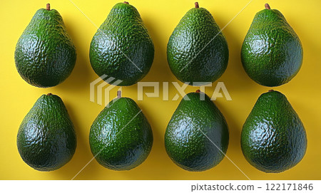 Whole avocados yellow background, top view avocado leaves, space for text, vegetarian food, vitamin 122171846