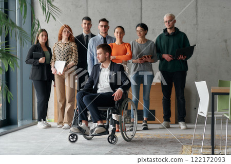 Multiethnic Business Team Collaborating in a Modern Office with Director in a Wheelchair 122172093
