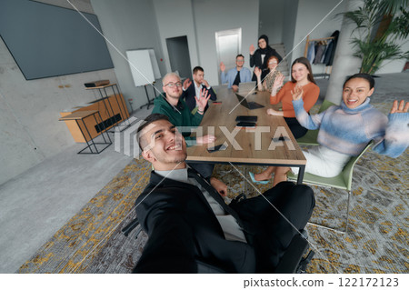 A group of business professionals taking a selfie during a break in an office meeting, capturing a moment of teamwork and collaboration in a modern workplace 122172123