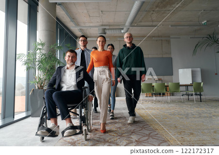 A diverse group of business professionals walking together through the office, symbolizing unity and strength as a collaborative and successful team 122172317
