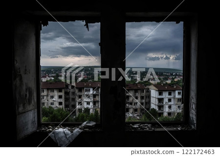 View of damaged buildings through abandoned window frame during cloudy weather 122172463