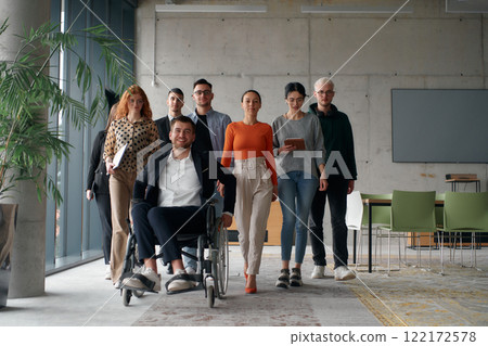 A diverse group of business professionals walking together through the office, symbolizing unity and strength as a collaborative and successful team A diverse group of business professionals walking together through the office, symbolizing unity and strength as a collaborative and successful team 122172578