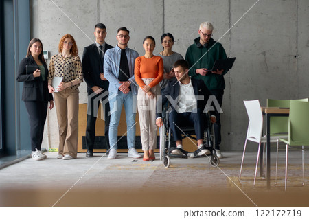 Multiethnic Business Team Collaborating in a Modern Office with Director in a Wheelchair 122172719