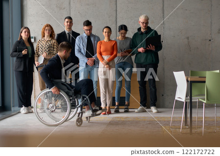 Multiethnic Business Team Collaborating in a Modern Office with Director in a Wheelchair 122172722