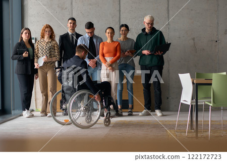 Multiethnic Business Team Collaborating in a Modern Office with Director in a Wheelchair 122172723