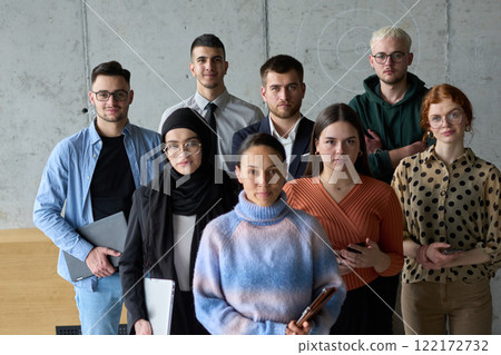 A diverse and determined team of business professionals stands confidently in an office, ready to tackle new business plans and challenges with a focus on success and growth 122172732