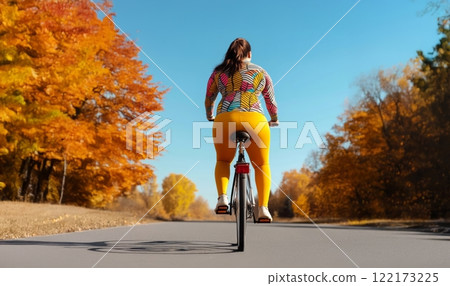 Confident Plus-Size Woman Enjoying a Bicycle Ride on a Crisp Autumn Morning. Generated image Confident Plus-Size Woman Enjoying a Bicycle Ride on a Crisp Autumn Morning. Generated image 122173225