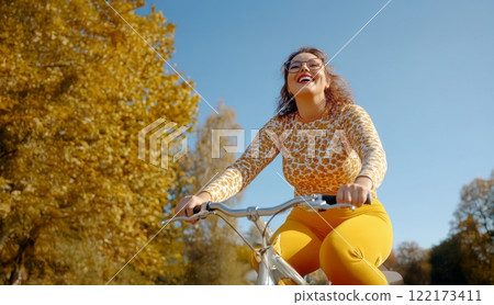 Confident Plus-Size Woman Enjoying a Bicycle Ride on a Crisp Autumn Morning. Generated image Confident Plus-Size Woman Enjoying a Bicycle Ride on a Crisp Autumn Morning. Generated image 122173411