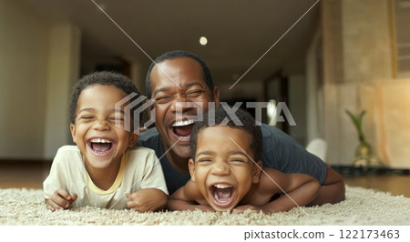 Father joyfully embracing his sons at home, lying on the floor and sharing laughter. Generated image 122173463