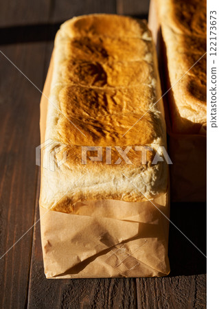 Freshly baked bread wrapped in wrapping paper 122173673
