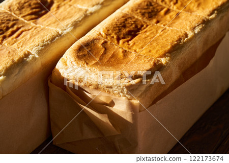 Freshly baked bread wrapped in wrapping paper 122173674