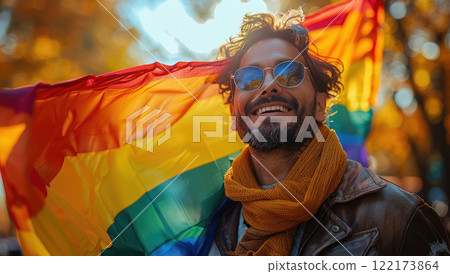 Happy multietnis gays mens having fun holding rainbow flag symbolizing LGBTQ community. 122173864