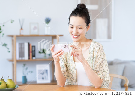 Young woman using a smartphone at home 122174831
