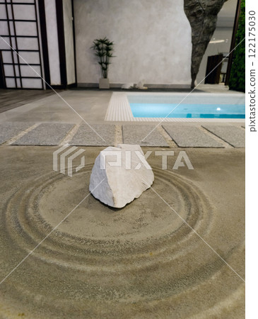 Zen stone on sand with ripples 122175030