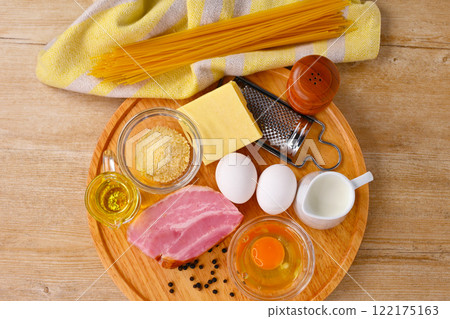 Ingredients for making Carbonara (Italian pasta): eggs, bacon, olive oil, cheese and milk. Ingredients for making Carbonara (Italian pasta): eggs, bacon, olive oil, cheese and milk. 122175163