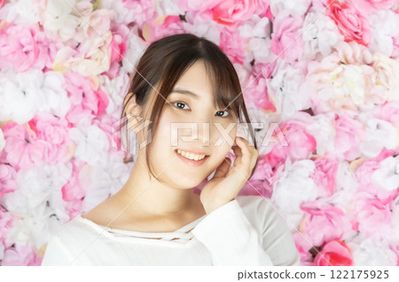 Young woman with flowers in full bloom Young woman with flowers in full bloom 122175925
