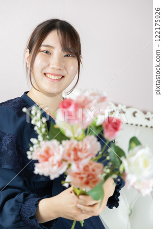 Young woman with flowers in bloom Young woman with flowers in bloom 122175926