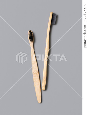 Two biodegradable bamboo toothbrushes on a light gray top view. Zero waste and no plastic concept Two biodegradable bamboo toothbrushes on a light gray top view. Zero waste and no plastic concept 122176320
