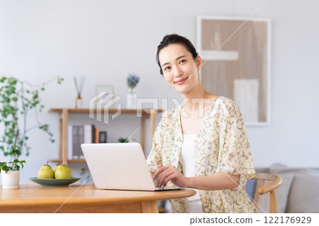 Young woman using a computer at home Young woman using a computer at home 122176929