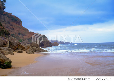 A rocky beach with a cloudy sky in the background. A rocky beach with a cloudy sky in the background. 122177898