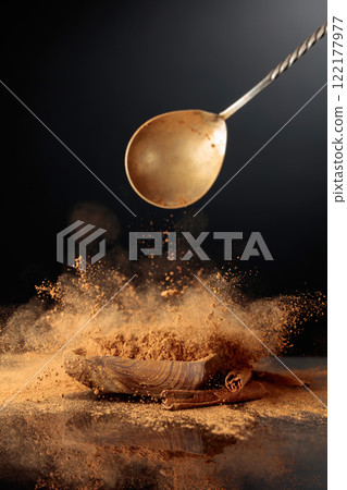 Cinnamon powder is poured into a wooden dish. Cinnamon powder is poured into a wooden dish. 122177977