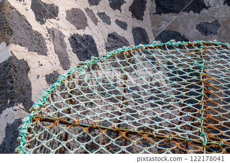 Abstract view on fishing net and wall, Spain Abstract view on fishing net and wall, Spain 122178041