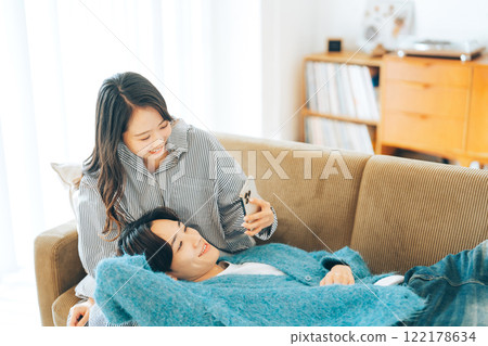 Young couple sleeping on each other's laps 122178634