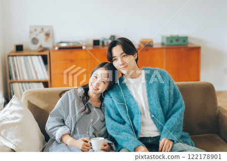 Young couple listening to music together 122178901