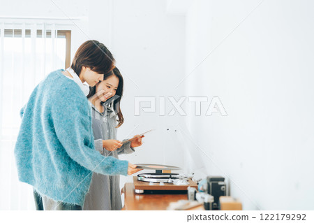 Young couple listening to records together Young couple listening to records together 122179292