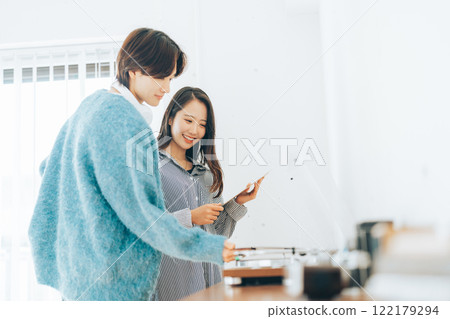 Young couple listening to records together Young couple listening to records together 122179294