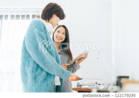 Young couple listening to records together Young couple listening to records together 122179295