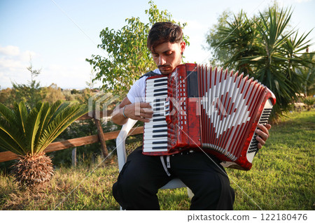 Joyful Melodies Flowing from Accordion Player 122180476