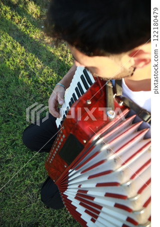 Joyful Melodies Flowing from Accordion Player 122180479