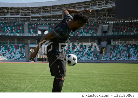 African American soccer player during match inside large stadium African American soccer player during match inside large stadium 122180862
