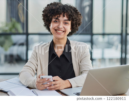 Portrait of Young Successful Caucasian Businesswoman Sitting at Desk Working on Laptop 122180911