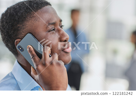 shot of confident young Afro-American man walking through lobby of busy office building, talking on smartphone and smiling shot of confident young Afro-American man walking through lobby of busy office building, talking on smartphone and smiling 122181242